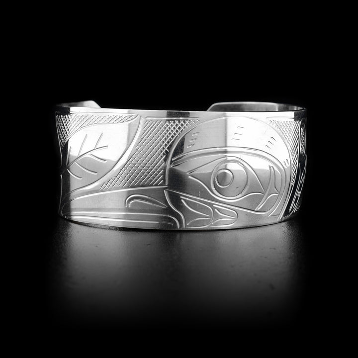 This sterling silver Hummingbird bracelet cuff has a wide band with a flower and a depiction of the Hummingbird carved into it. 