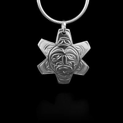 This sterling silver pendant is shaped like the Sun and has carvings in it depicting the Sun.
