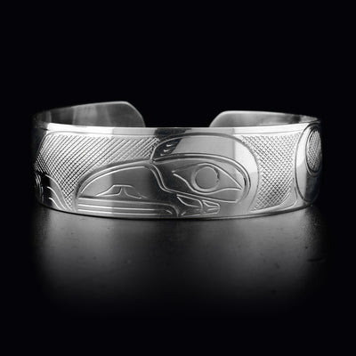 This sterling silver cuff bracelet has a wide band with a beautiful depiction of the Raven carved into its surface.