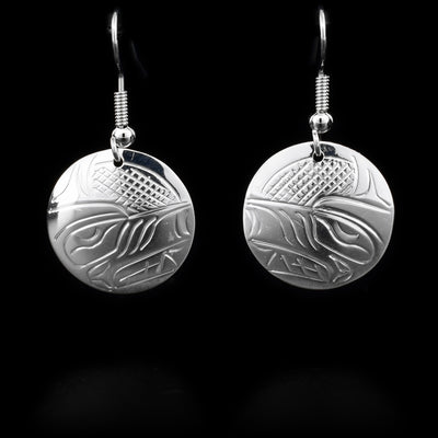 These sterling silver earrings have hooks which have round hangs. The round hangs depict the face of the Wolf.