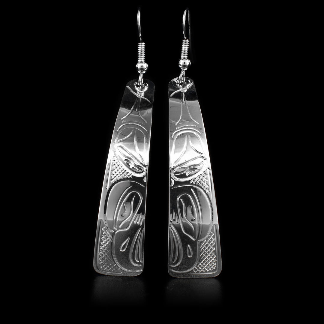 These dangling sterling silver earrings have long hangs with a depiction of the Eagle carved into them.