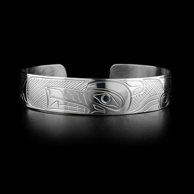 This sterling silver cuff bracelet has a depiction of the Wolf carved into it.