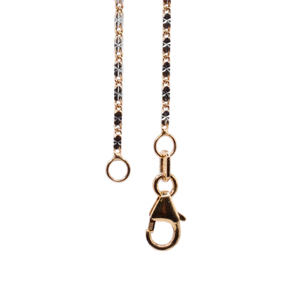 This gold chain necklace has long and thin chain links that have a two tone design achieved by combining 14K yellow gold and 14K white gold.
