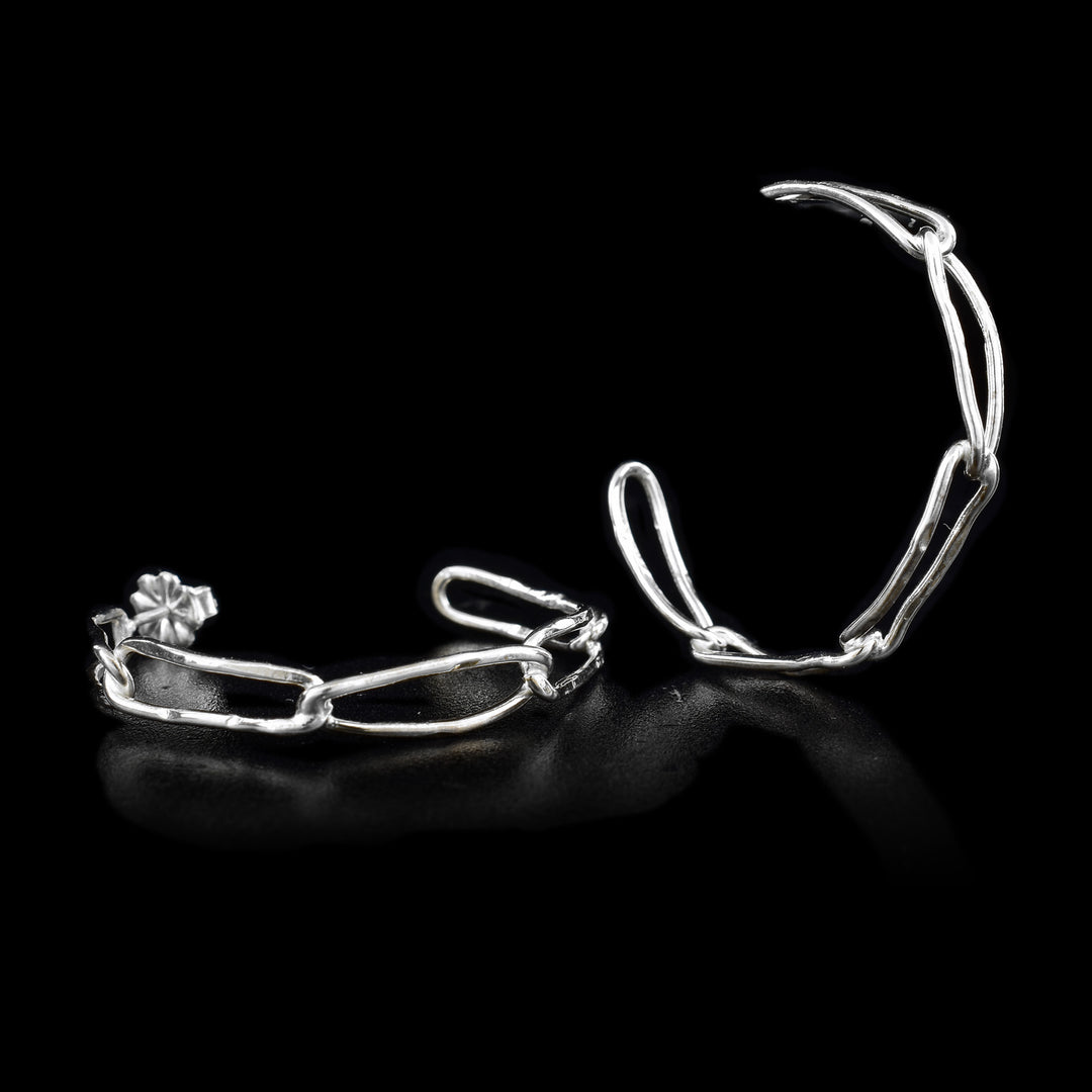 These sterling silver hoop earrings are made from long chain links attached to each other and form a hoop.