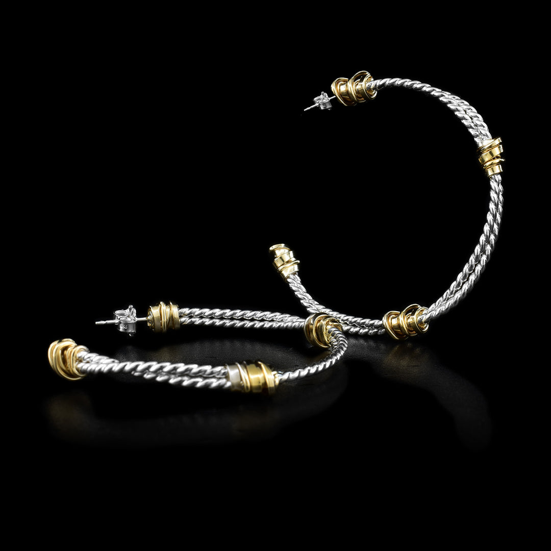 These sterling silver, coil hoop earrings are made of two coils that are held together by gold fill wrapped around them.