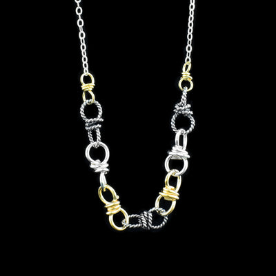 A sterling silver chain that has a 4 1/2" section of a big chain in the middle. The big chain section is made out of sterling silver, oxidized silver, and gold fill.