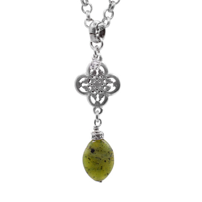 This genuine jade pendant is made from jade, sterling silver and cubic zirconia. There is an oval shaped jade gem dangle from a silver, lace design above it. There are cubic zirconia gems set above the jade and attached to the lacey pendant.