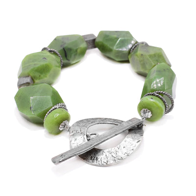 This chunky, beaded jade bracelet has natural looking jade beads on an antique silver chain and adornments.