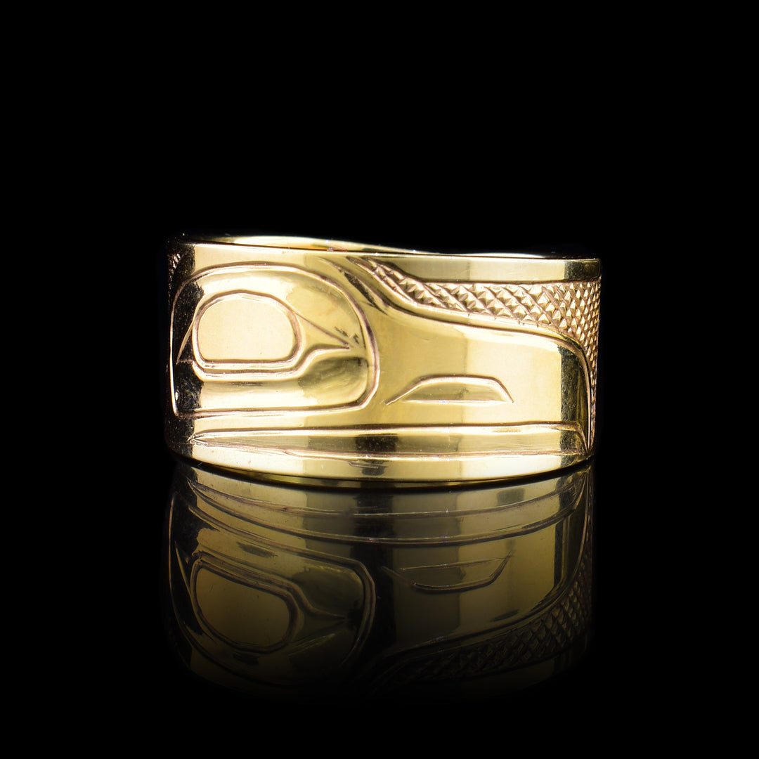 This 14K gold ring has a tapered band with a depiction of the Raven carved into it.