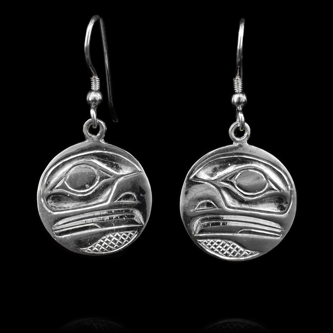 These sterling silver dangle earrings have circle shaped hangs with depictions of the Eagle that have been repoussed into the hangs.