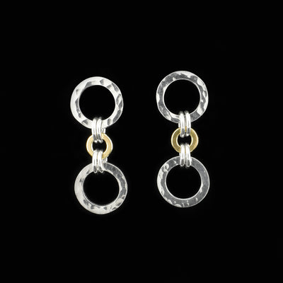 Studs are made up of rings. Two big sterling silver ones on top and bottom with dented effect. Small 14K gold one in middle connected to big rings by sterling silver jump rings.