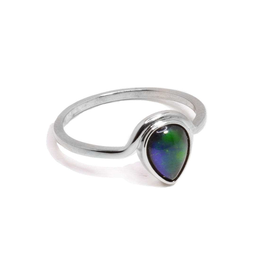 This sterling silver ammolite ring has a thin, silver band that wraps around a teardrop shaped ammolite gem at the top of the ring.