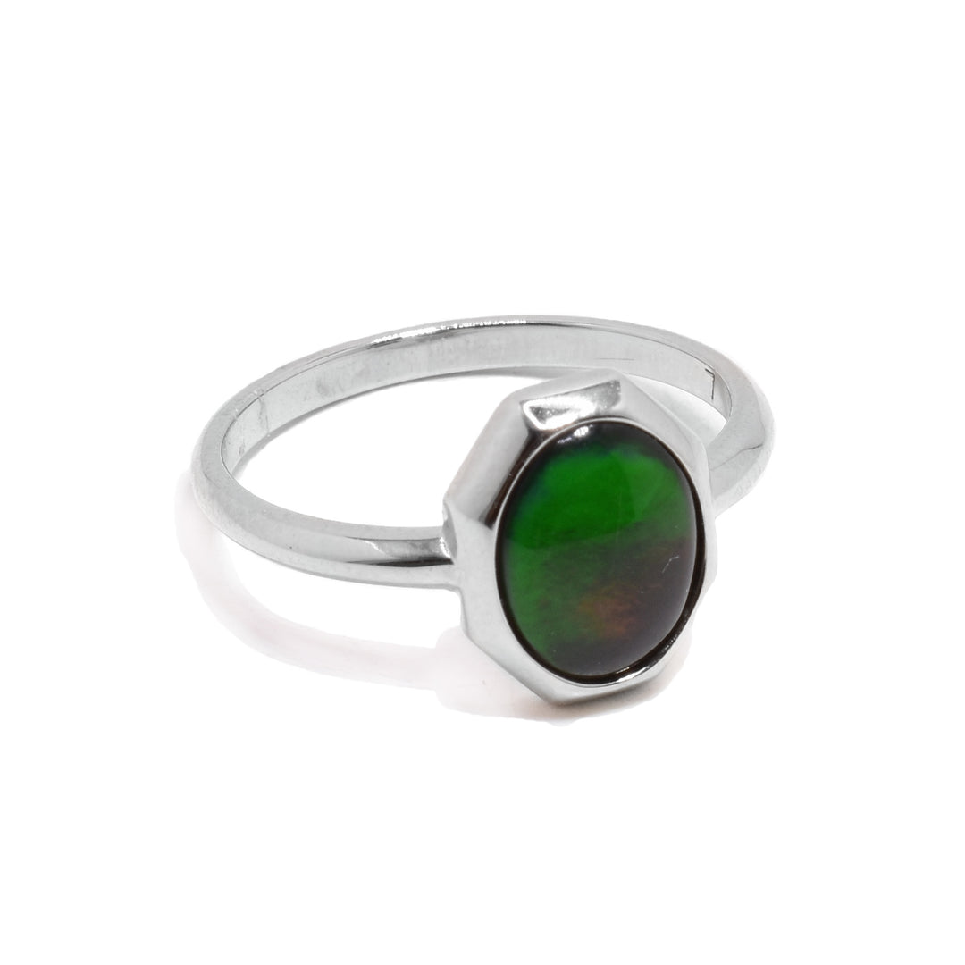 This sterling silver, ammolite ring has a thin band and a oval shaped ammolite gem held at the top of the ring.