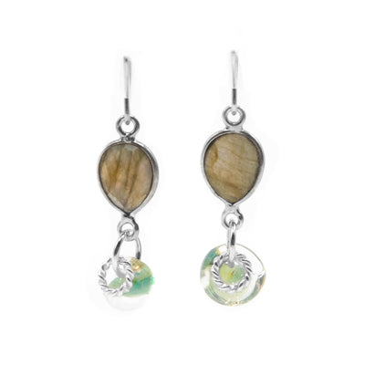 Faceted, downward teardrop-shaped labradorite dangles from hooks. Labradorite-like glass adornment and silver ring adornment dangle below gemstone. All metal is sterling silver.