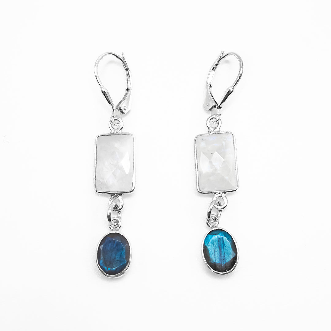 Sterling silver lever-back earrings with dangling rectangular faceted moonstone. A smaller, faceted, oval piece of labradorite dangles below the moonstone.