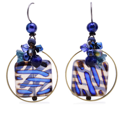 Dangle drop earrings made of freshwater pearls, lampworked glass, Austrian crystal and glass. Titanium hooks. By Honica.