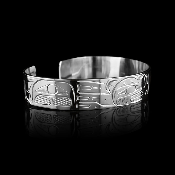 Large Bear and Salmon Bracelet, made with sterling silver by a talented indigenous artist the Bear sits on one side and the salmon on the other where they meet in the middle.