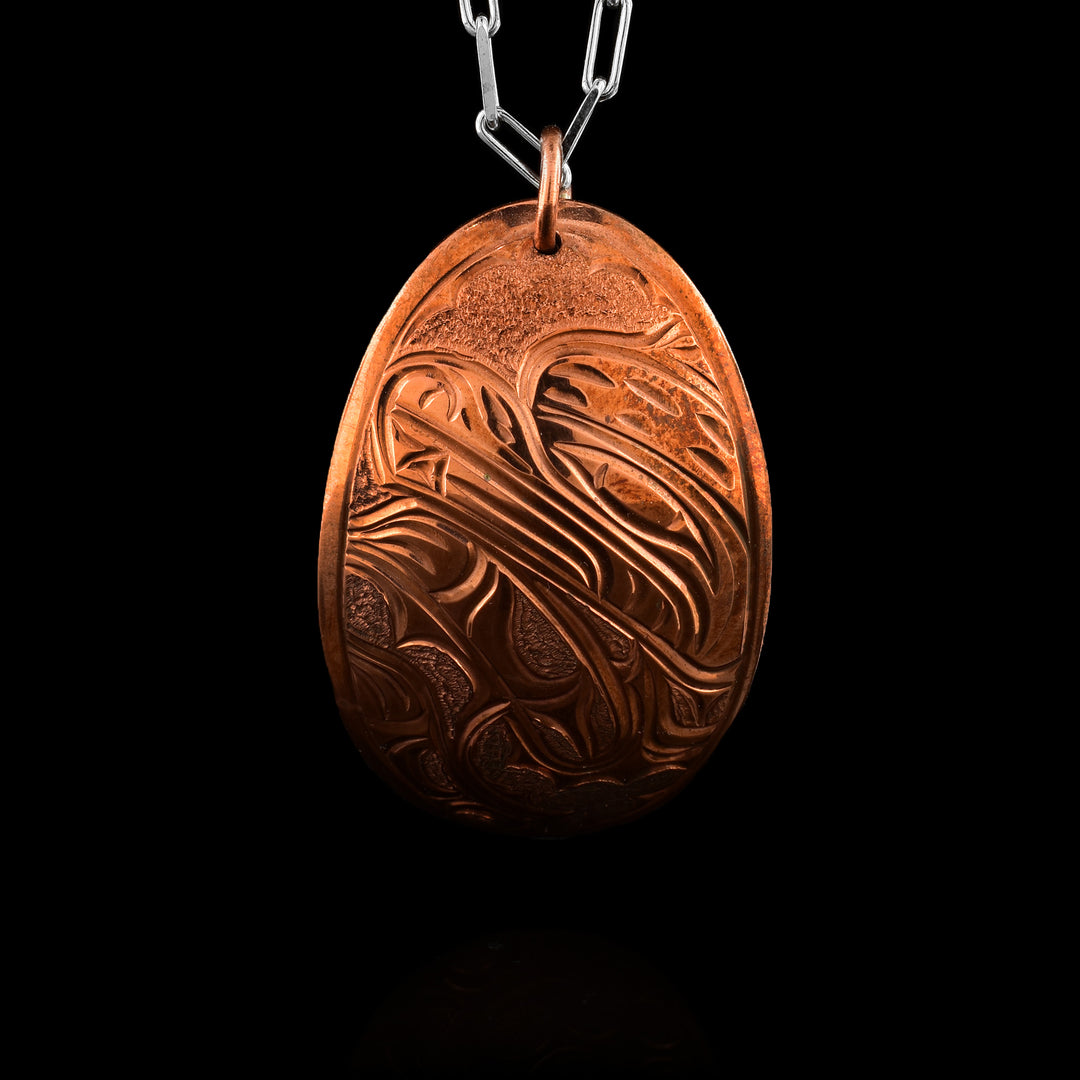 Curved oval pendant with bear hand-carved by Kwakwaka’wakw artist Cristiano Bruno.