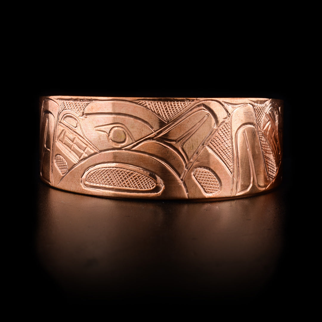 Front of bracelet features swimming orca pod. Hand-carved by Kwakwaka’wakw artist Norman Seaweed.