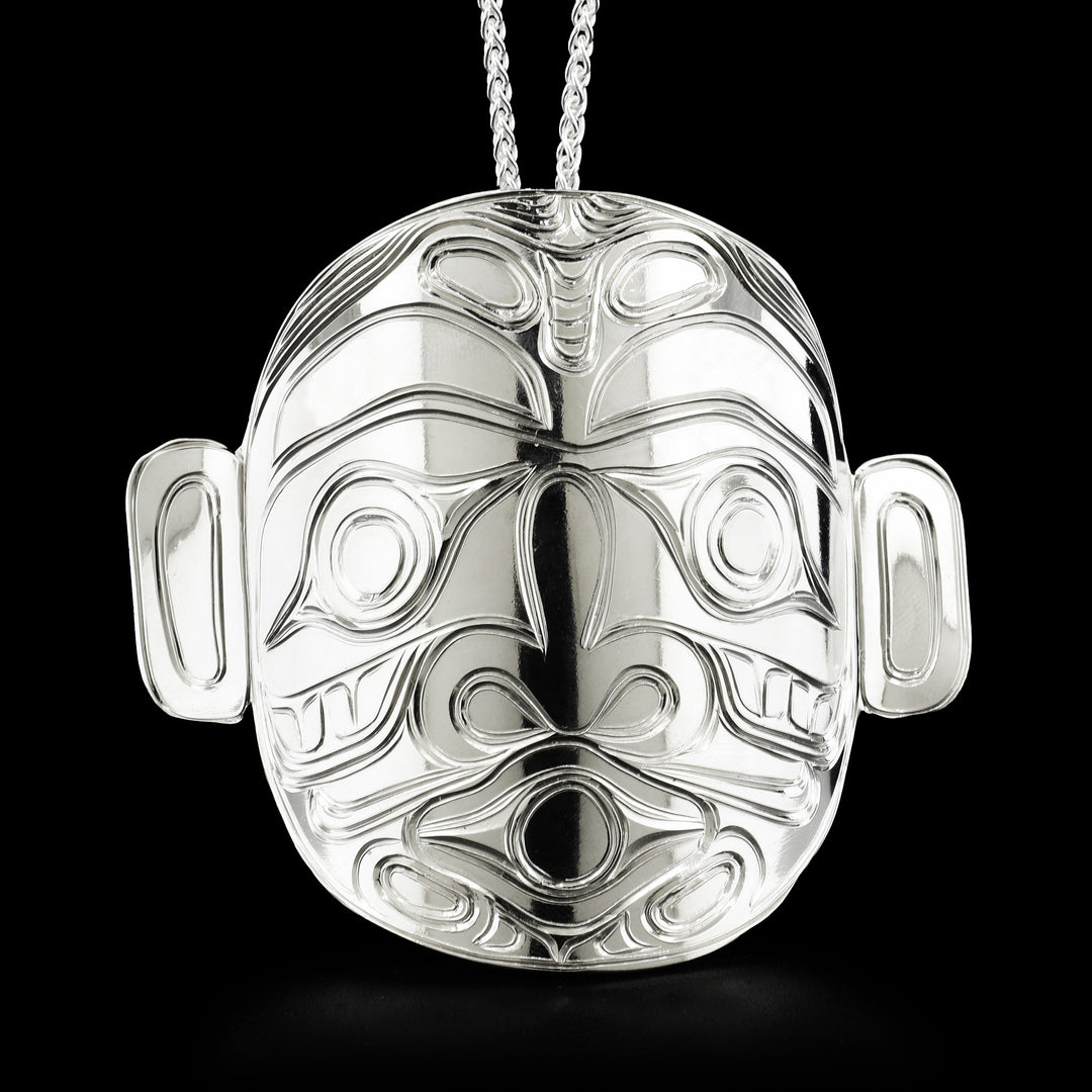 Pendant depicts the face of Dzunuk’wa, the wild woman of the woods. Hidden bail on back. By Kwakwaka’wakw artist Paddy Seaweed.