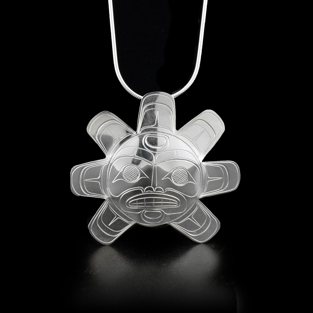 This Sun pendant is made from sterling silver and is shaped like the Sun. There are seven sun "rays" all around the pendant beside right at the bottom (there is not sunray pointing straight down). There are carvings on the surface of the pendant that depict the Sun.
