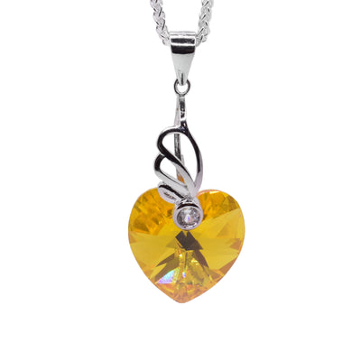 Sterling silver heart shaped light topaz Swarovski crystal pendant by artist Debra Nelson.