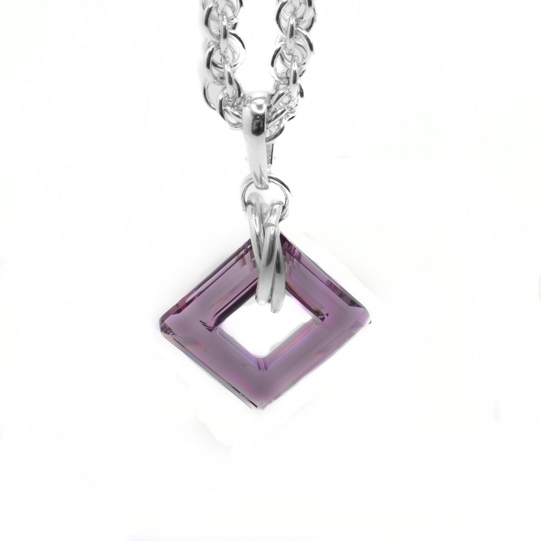 This dazzling crystal pendant has a square shaped hoop made from square shaped antique pink Swarovski crystal. The pendant hangs from a sterling silver chain link and has three chain links wrapped around it.
