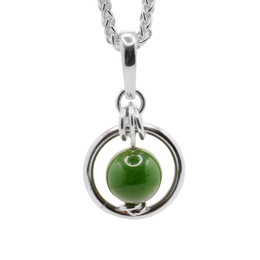 This jade pendant has a BC jade bead with a sterling silver hoop around it. There are smaller silver hoops attached to the larger hoop.