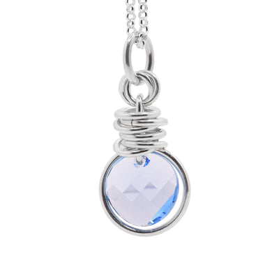 This sterling silver crystal pendant is made of various hoops  and has a circle aqua Swarovski crystal on it.