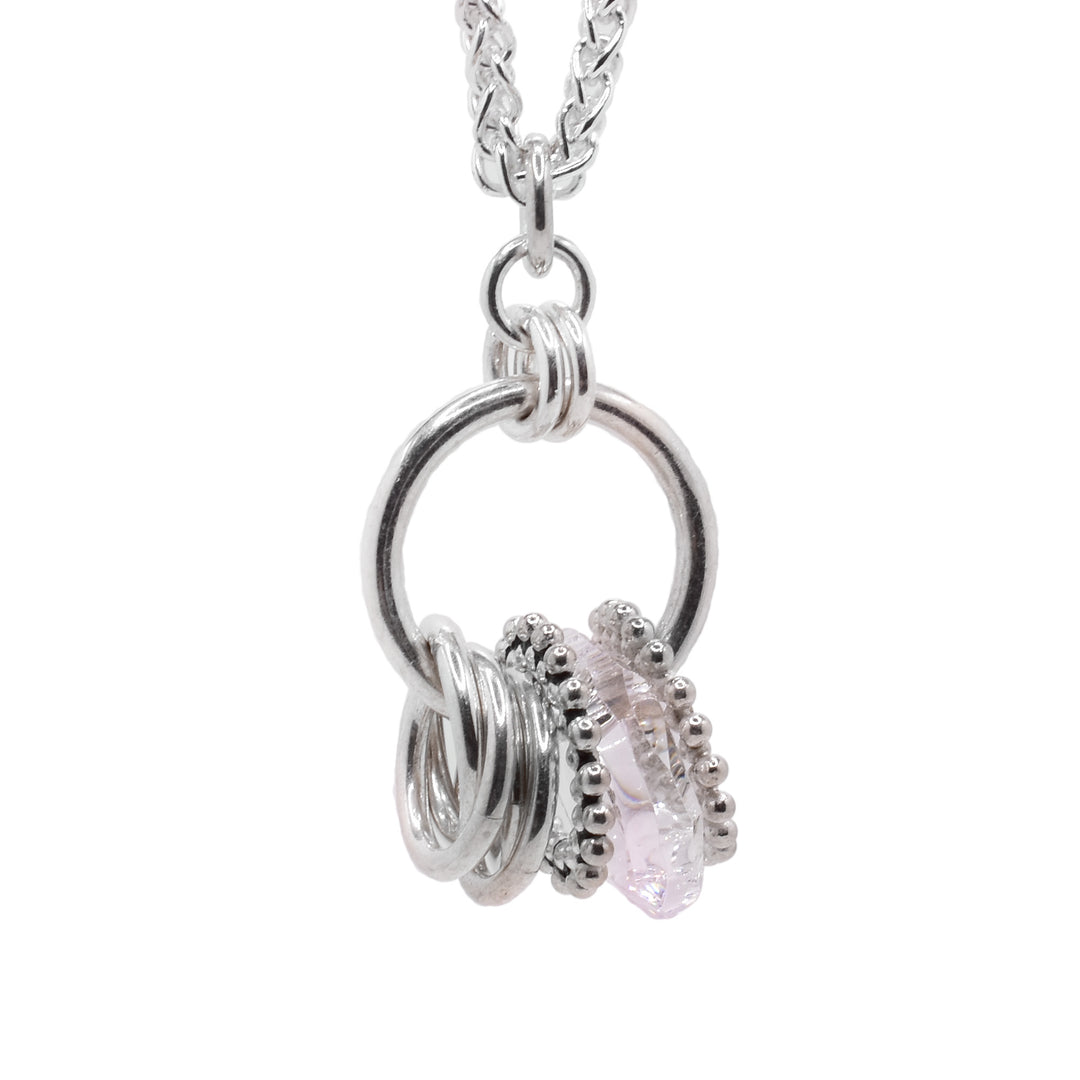 This sterling silver crystal pendant has a large hoop with smaller silver hoops linked through it. There is also an urban smoke Swarovski crystal hoop and silver beaded hoops.