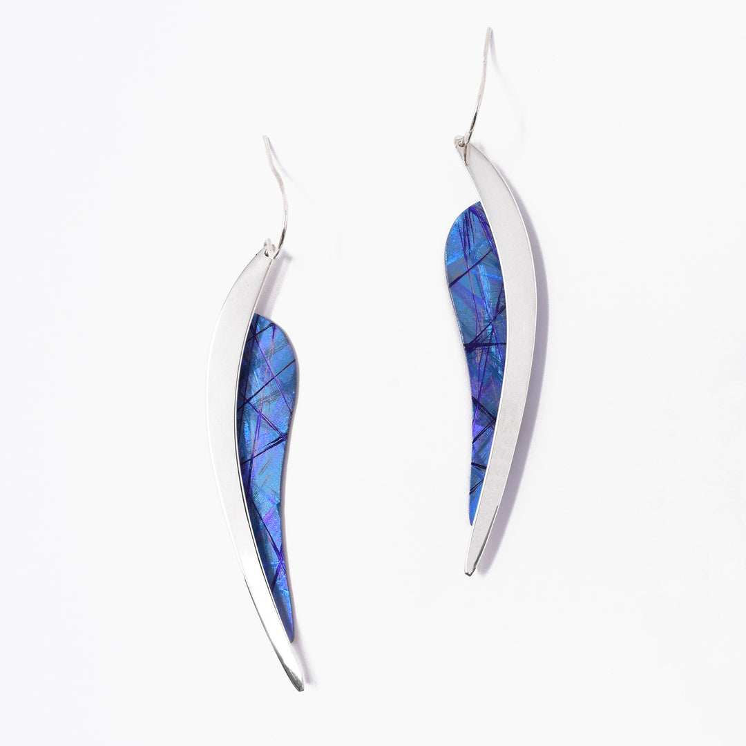 Long leaf-shaped earrings pointing downwards. Made of sterling silver and anodized titanium. Titanium part is a dazzling blue-purple.