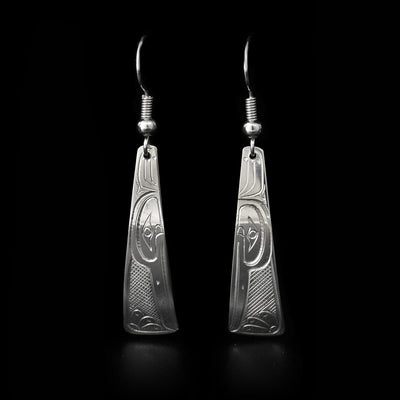 Domed, triangular sterling silver earrings with hummingbird heads facing downwards. Cross-hatching background. Dangle earrings hand-carved by Coast Salish artist Travis Henry.