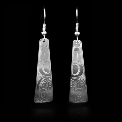 Domed, triangular sterling silver earrings with orca heads facing downwards. Cross-hatching background. Dangle earrings hand-carved by Coast Salish artist Travis Henry.