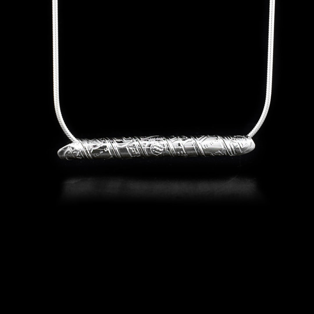 Strip of sterling silver depicting wolf, wrapped into a spiral. Horizontal.