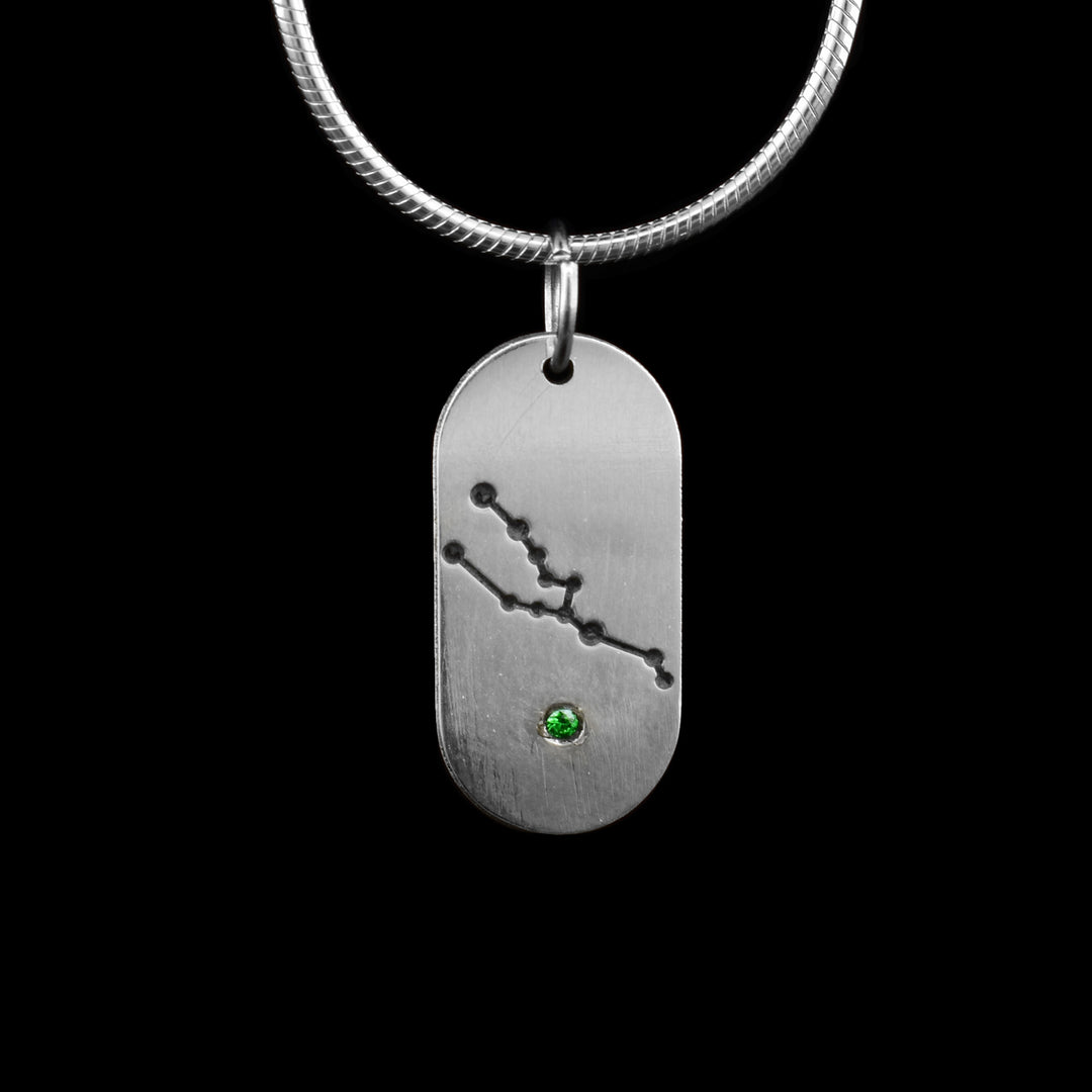 This May Zodiac Sign Pendant, crafted in sterling silver, features the intricate constellation of Taurus, honouring those born in May. A brilliant green cubic zirconia, symbolizing the May birthstone, is set at the base