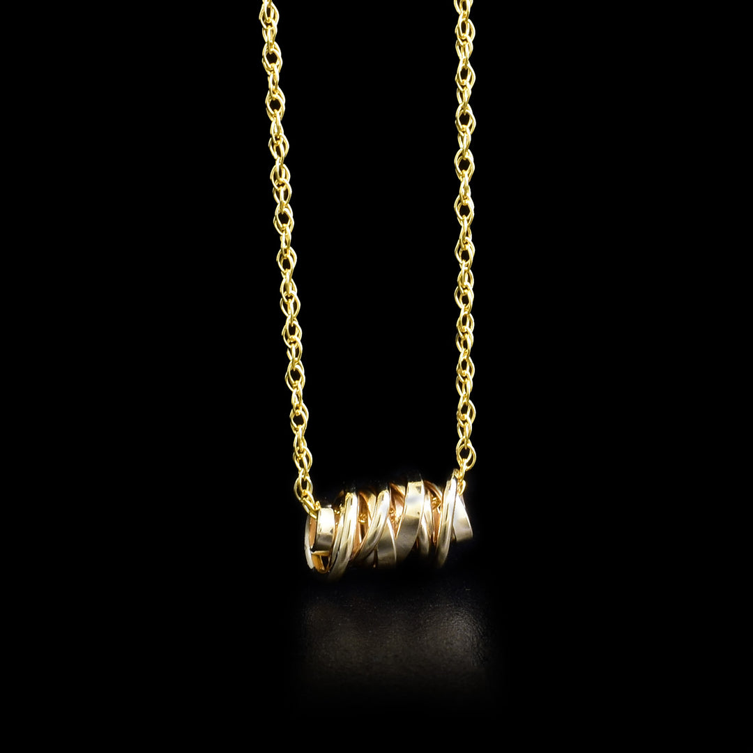 Mini gold-fill coil pendant necklace by artist Joy Annett.