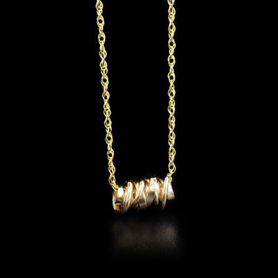 Mini gold-fill coil pendant necklace by artist Joy Annett.