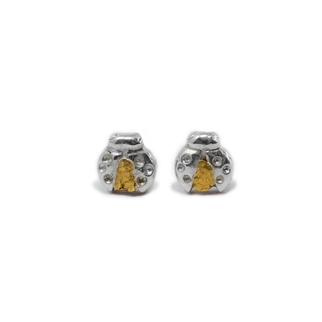 Sterling silver ladybugs with wings slightly open. 22K gold nuggets underneath. Handcrafted by Tom Gregorczyk.