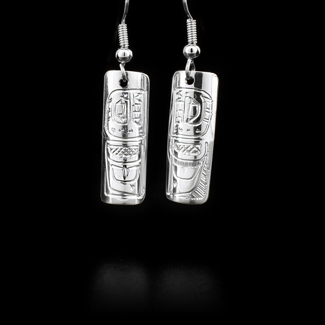 Rectangular sterling silver dangle earrings featuring orcas. By Coast Salish artist Jeffrey Pat.