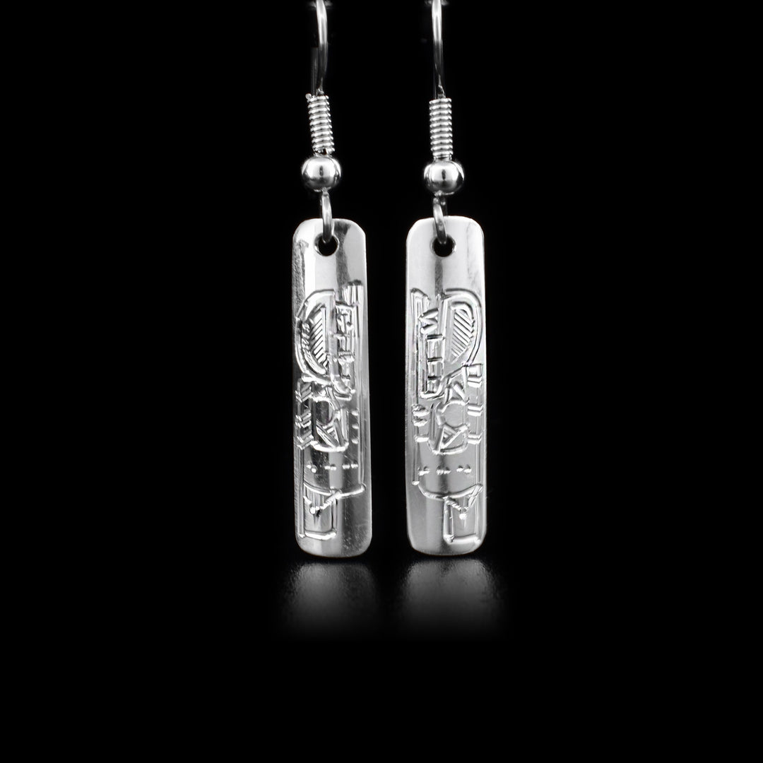 Rectangular sterling silver dangle earrings featuring bears. By Coast Salish artist Jeffrey Pat.
