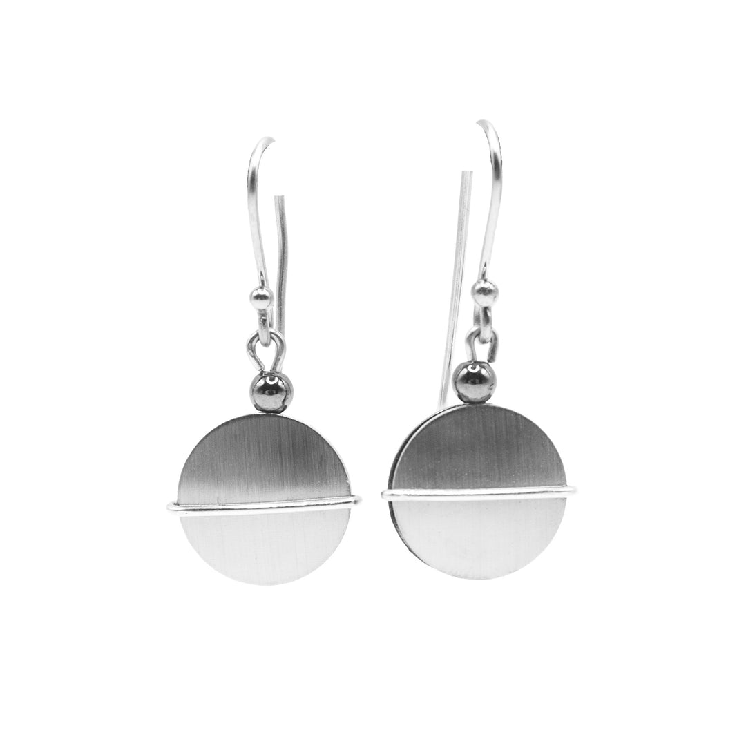 Minimalist brushed and anodized aluminum circle dangle earrings with hematite beads and stainless steel hooks. By JR Franco.