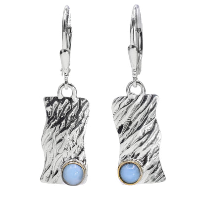 These unique gemstone dangle earrings are made from sterling silver, 14K gold and larimar gemstones. The hangs are wavy, rectangular and have a rippled textures on the surface of them. There is a circle larimar gem placed in the corner and is held in gold.