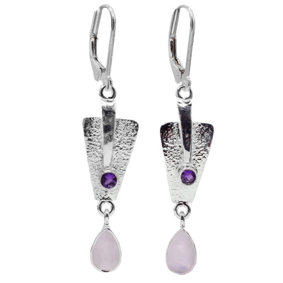 These dangling moonstone earrings are made from sterling silver, genuine amethyst and moonstone gems. The hangs are shaped like upside down, triangles that dangle from the hooks. There are teardrop shaped gems dangling from the triangle pieces which also have a textured surface. 