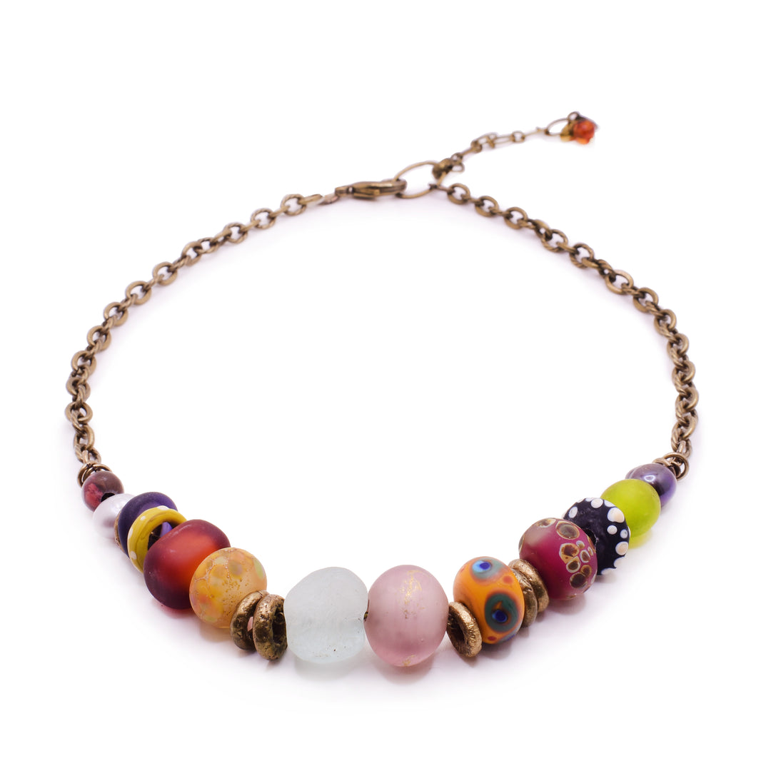 Multi-Color Glass Bead Brass Tone Necklace. the front of the necklace is covered with multiple colour beads and its strung on a brass chain. 