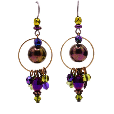 Purple and green dangle earrings made of glass and hematine. Titanium ear hooks. By Honica.