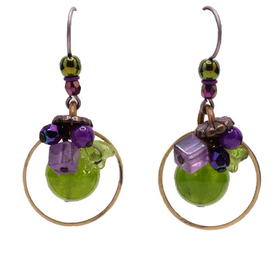 Dangle earrings made of faceted glass, fossil stone, dyed quartz, amethyst, glass and brass. Titanium hooks. By Honica.