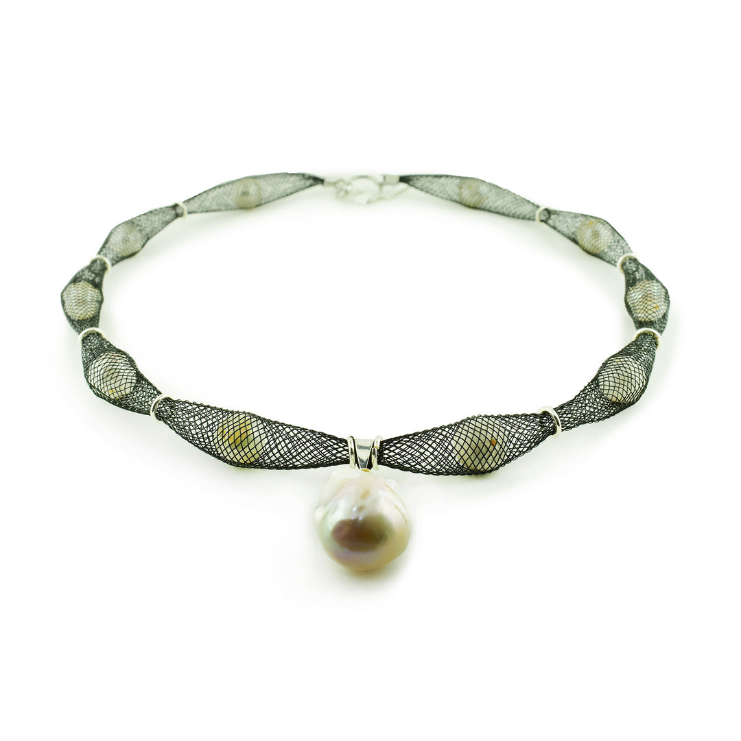 Elevate your style with our artisan black mesh necklace. Lustrous pearls are hand-netted and finished with a bold, organic baroque pearl centerpiece. One-of-a-kind design.