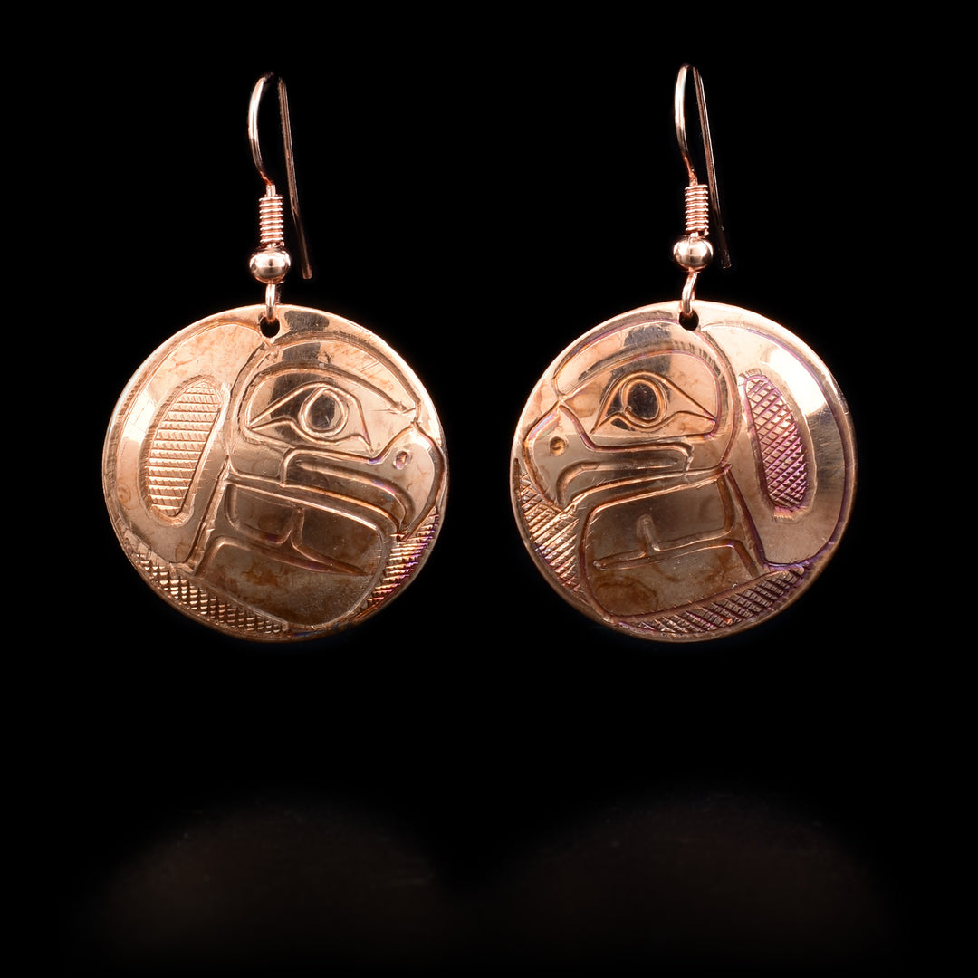 These Eagle earrings are made of copper and have circular hangs that have depiction of the Eagle carved into them.