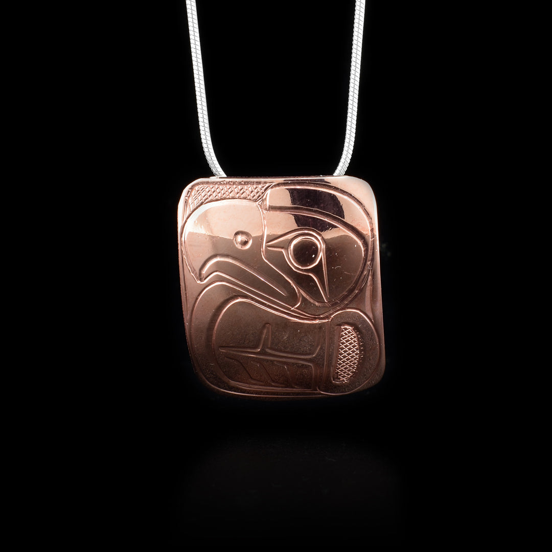 This Eagle pendant is made from copper and is square shaped. There is a depiction of the Eagle carved into the surface of the pendant.