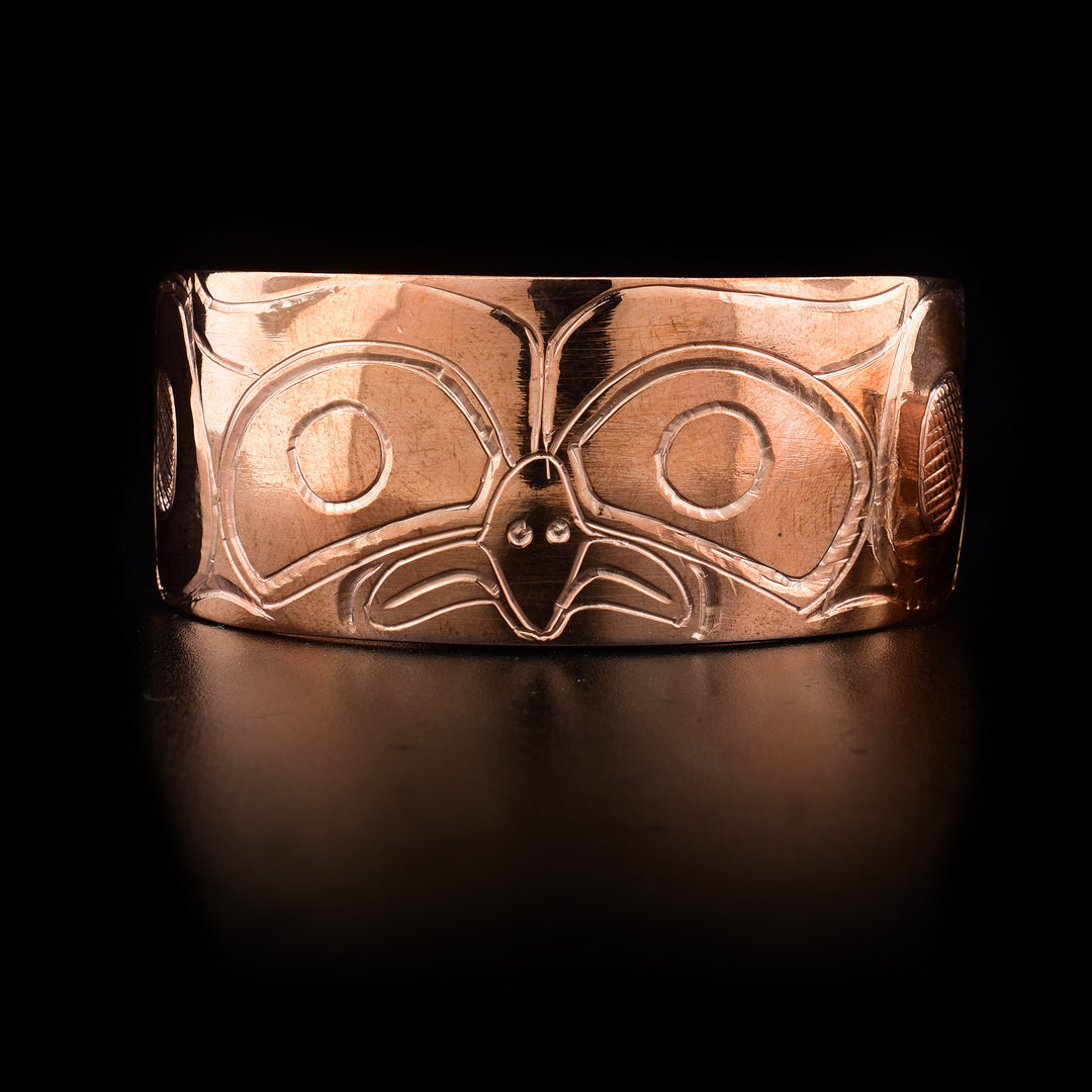 This Owl bracelet cuff has a wide, copper band with a depiction of the Owl carved into it.